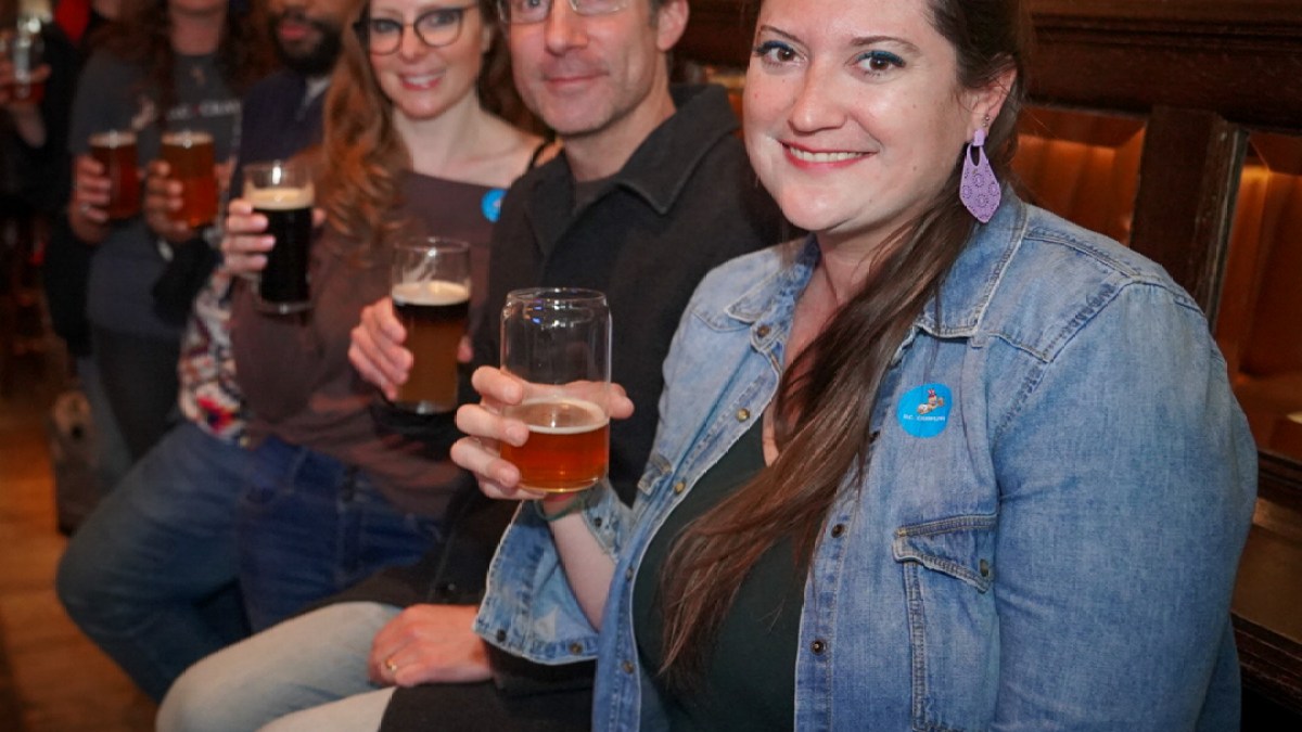 a group of people holding wine glasses and smiling at the camera